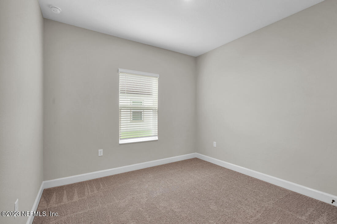718 Morgans Treasure Road St. Augustine, FL 32084 - Photo 7 of 9 an empty room with a window