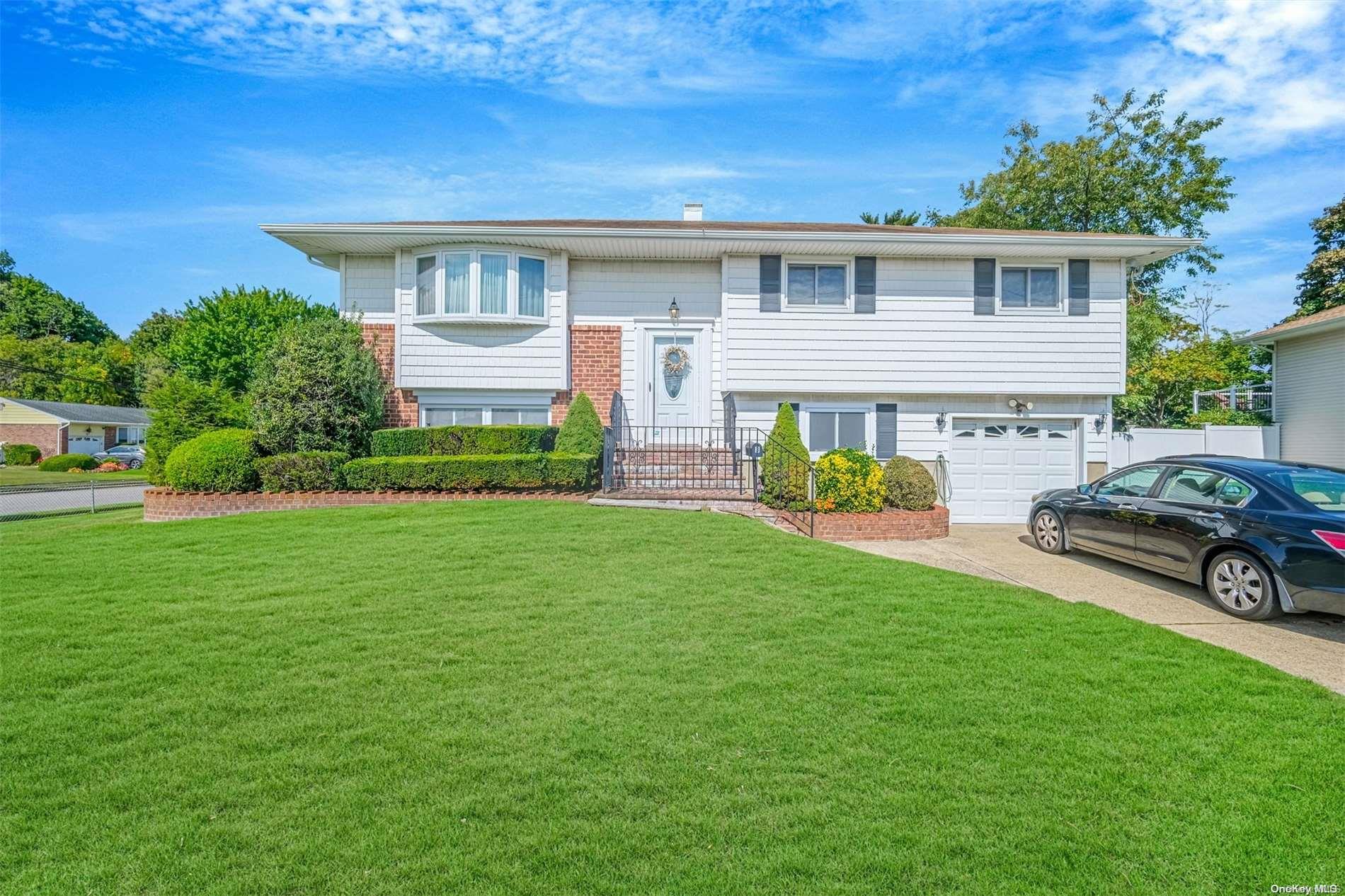 3 Headline Road Deer Park, NY 11729 - Photo 1 of 1 a front view of a house with garden