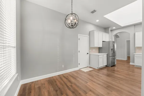 a large white kitchen with stainless steel appliances