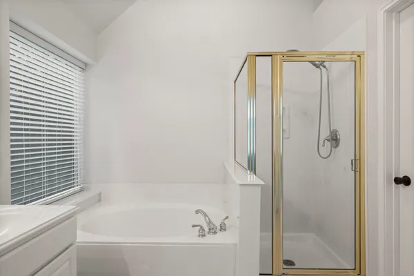 a bathroom with a double vanity sink mirror and shower