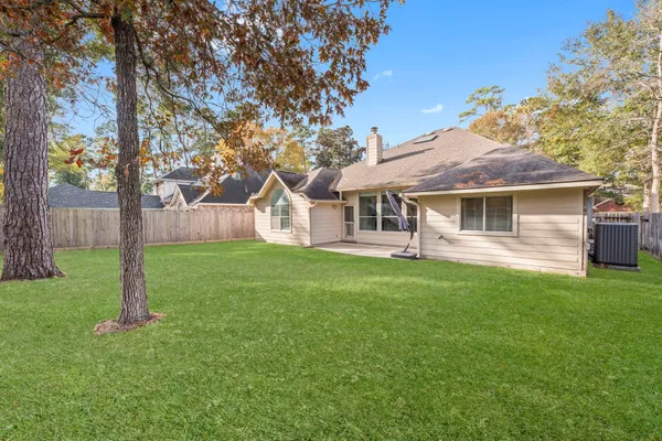 a view of a backyard with a garden and entertaining space