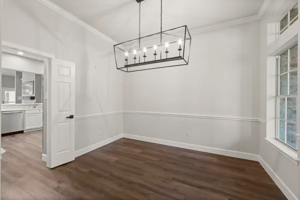 a view of a room with wooden floor and windows