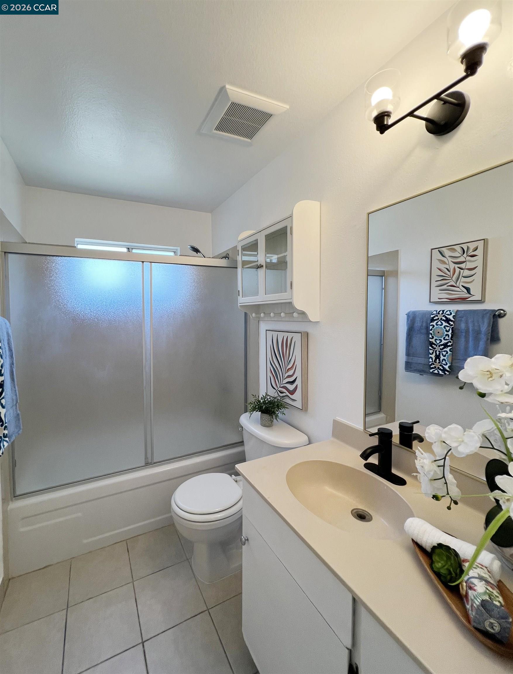 9085 Alcosta Boulevard, Unit 424 San Ramon, CA 94583 - Photo 9 of 21 a bathroom with a sink toilet and shower