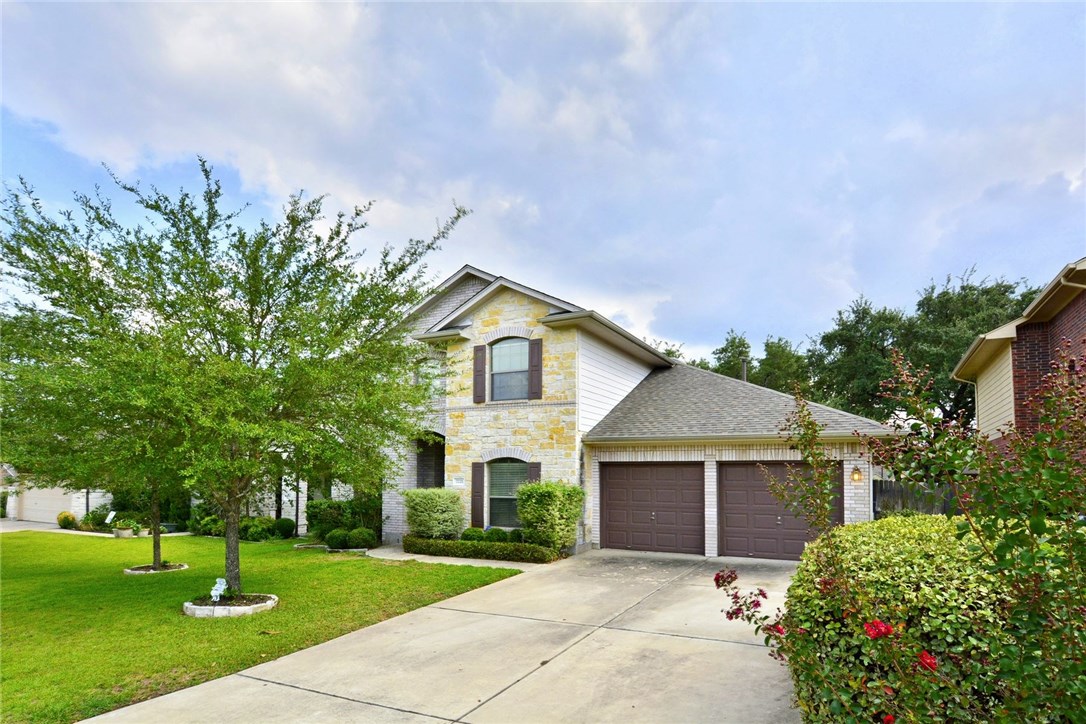 a front view of house with yard and green space