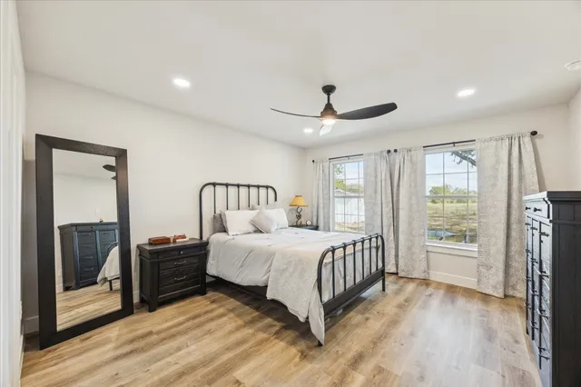 a bedroom with a bed and a large window