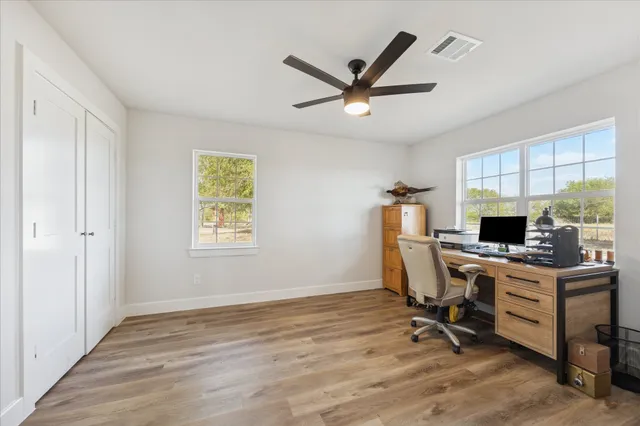 a workspace with wooden floor and a window