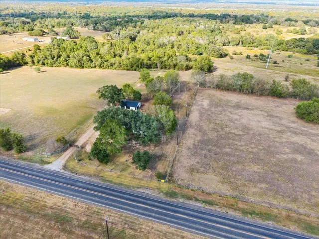 an aerial view of beach and residential houses with outdoor space