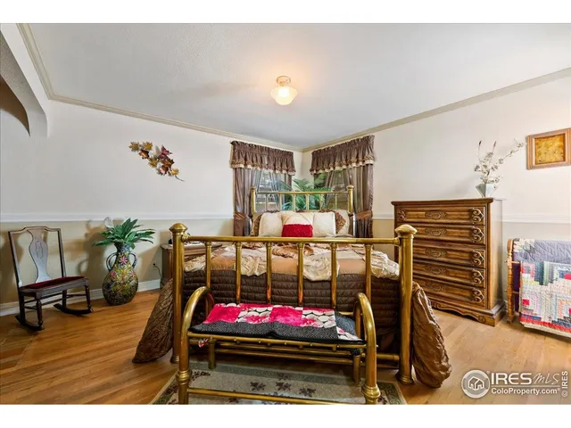 a bedroom with furniture and flat screen tv