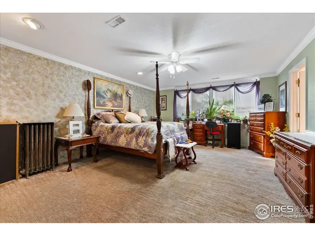a bedroom with furniture and a large window