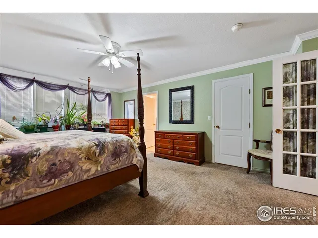 a bedroom with a bed dresser and a window