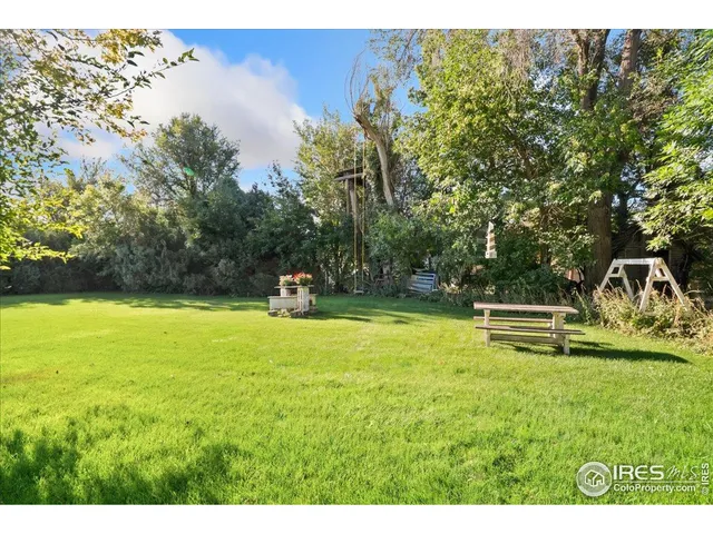 a view of a swimming pool with a yard