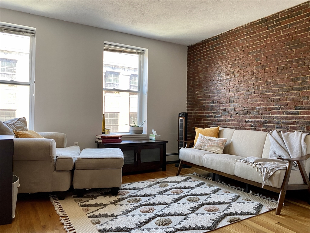 178 North Street, Unit 4 Boston, MA 02113 - Photo 4 of 8 a living room with furniture wooden floor and a table