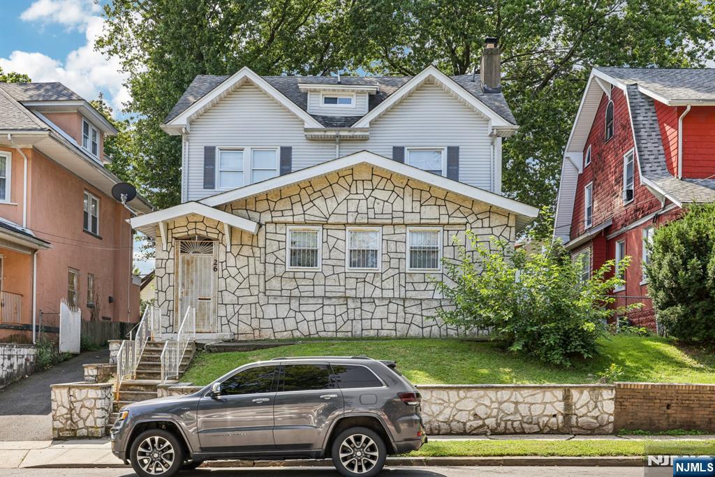 a front view of a house with a garden