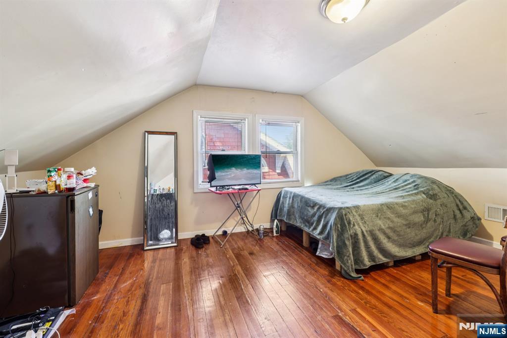 28 Scheerer Avenue Newark, NJ 07112 - Photo 19 of 39 a bedroom with a bed and wooden floor