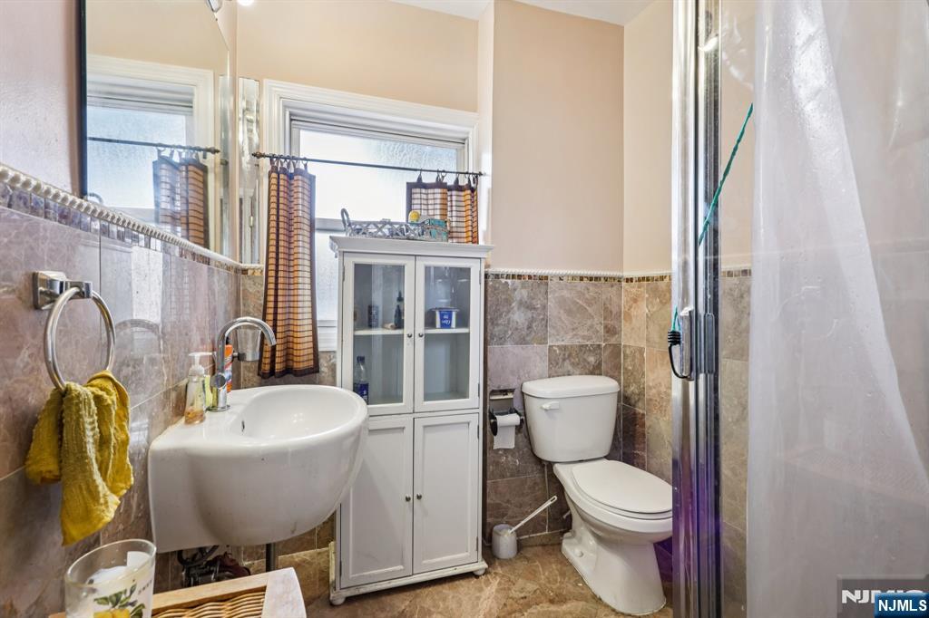 28 Scheerer Avenue Newark, NJ 07112 - Photo 26 of 39 a bathroom with a toilet a sink and shower