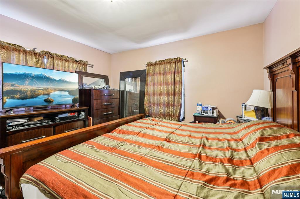 28 Scheerer Avenue Newark, NJ 07112 - Photo 31 of 39 a bedroom with a bed and a flat screen tv