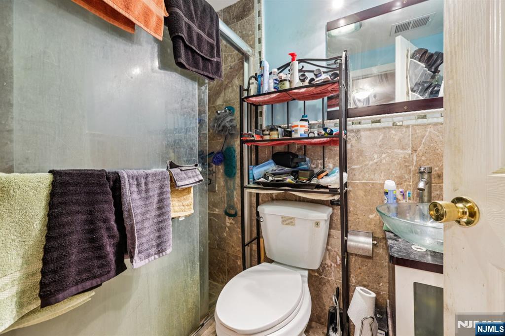 28 Scheerer Avenue Newark, NJ 07112 - Photo 33 of 39 a bathroom with a toilet sink and mirror