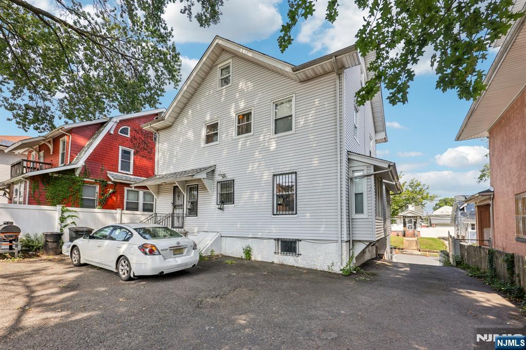 28 Scheerer Avenue Newark, NJ 07112 - Photo 37 of 39 a view of a white house with large windows next to a road