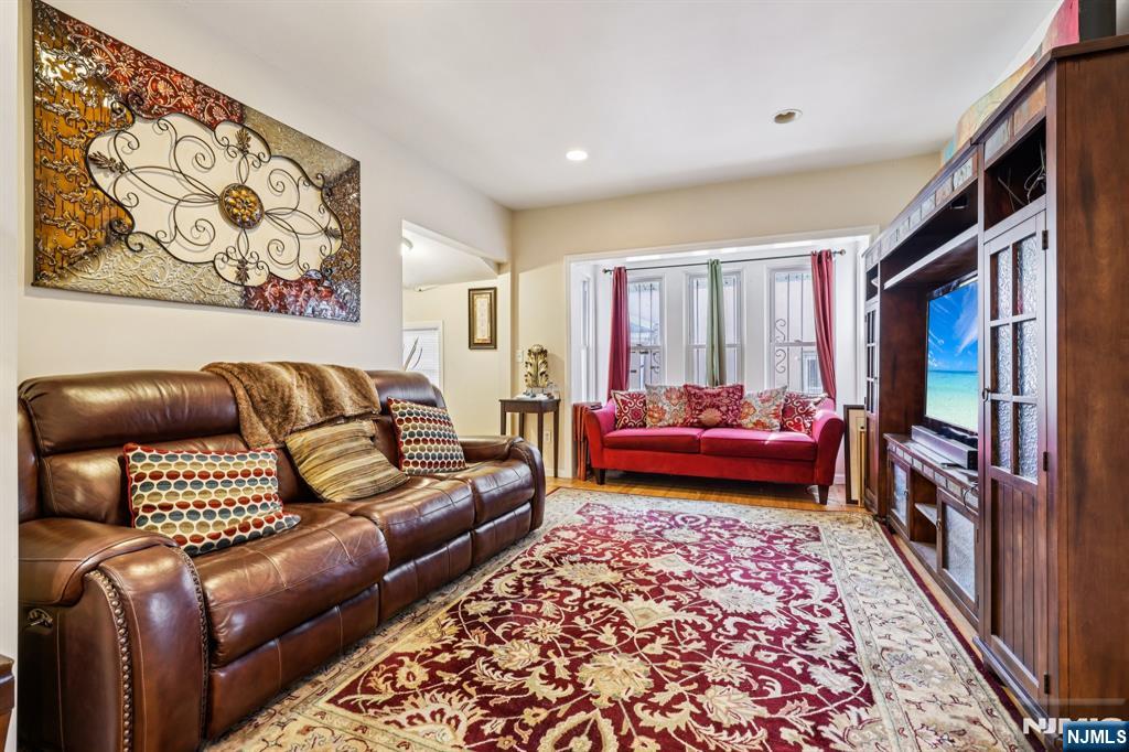 28 Scheerer Avenue Newark, NJ 07112 - Photo 7 of 39 a living room with a couch and a rug