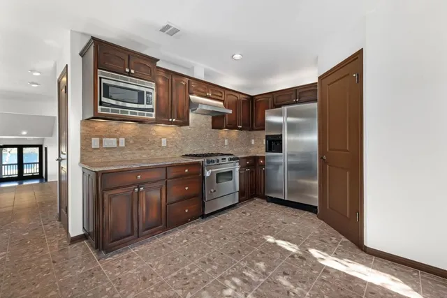 a view of an empty room with closet