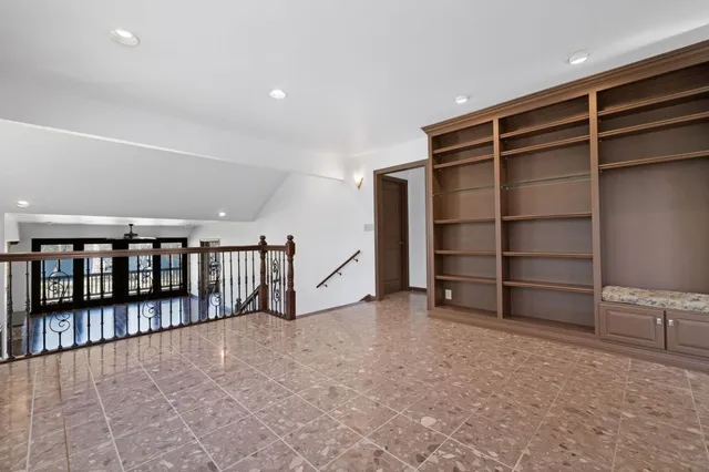 a living room with fireplace furniture wooden floor and a large window