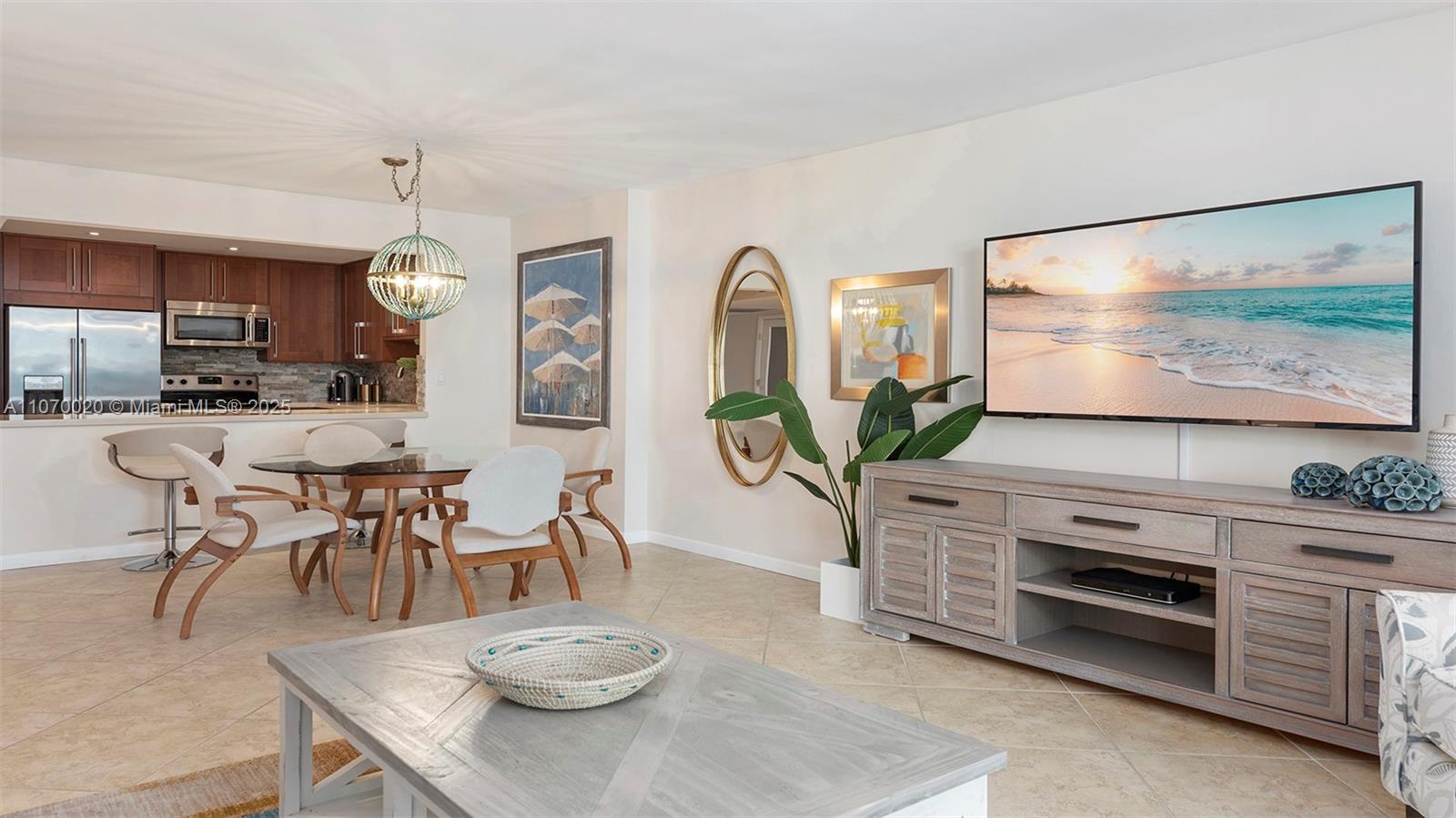 2301 Collins Avenue, Unit 301 Miami Beach, FL 33139 - Photo 7 of 19 a view of a dining room with furniture and a flat screen tv