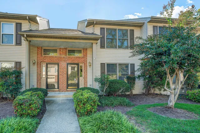 front view of a brick house with a yard