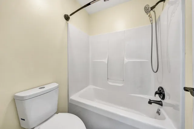 a bathroom with a toilet and a bathtub