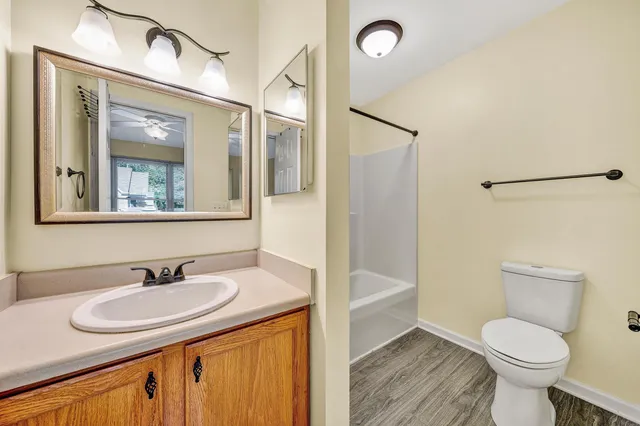 a bathroom with a granite countertop sink toilet and shower