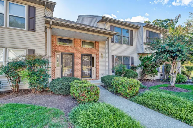 a front view of a house with garden and porch