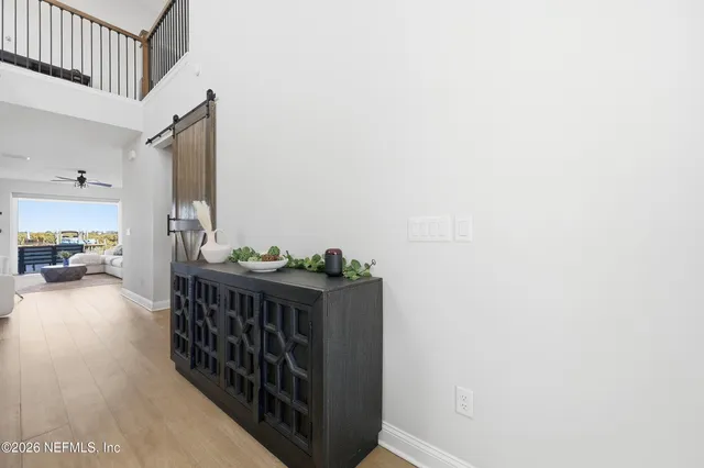 a living room with furniture and a view of kitchen