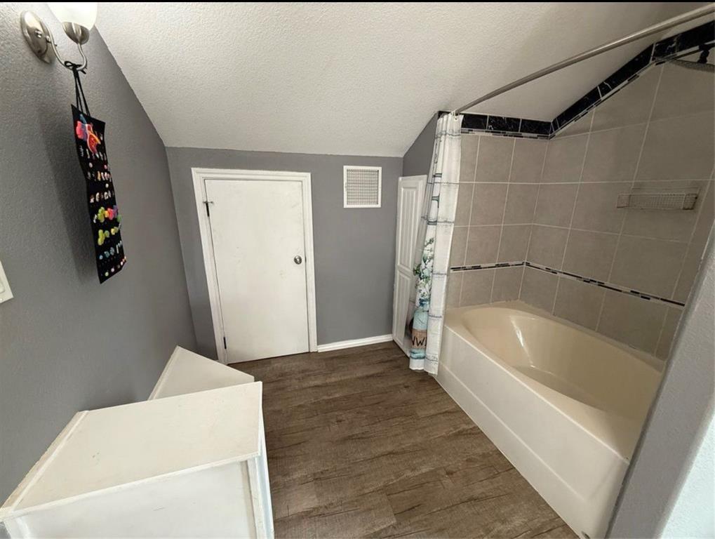400 North Ave A Springtown, TX 76082 - Photo 13 of 19 a bathroom with a tub a rug and a shower