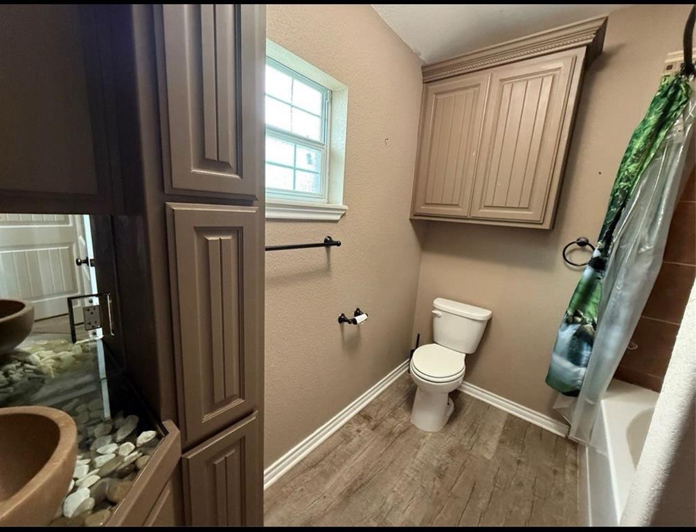 400 North Ave A Springtown, TX 76082 - Photo 14 of 19 a white toilet sitting next to a bathroom sink