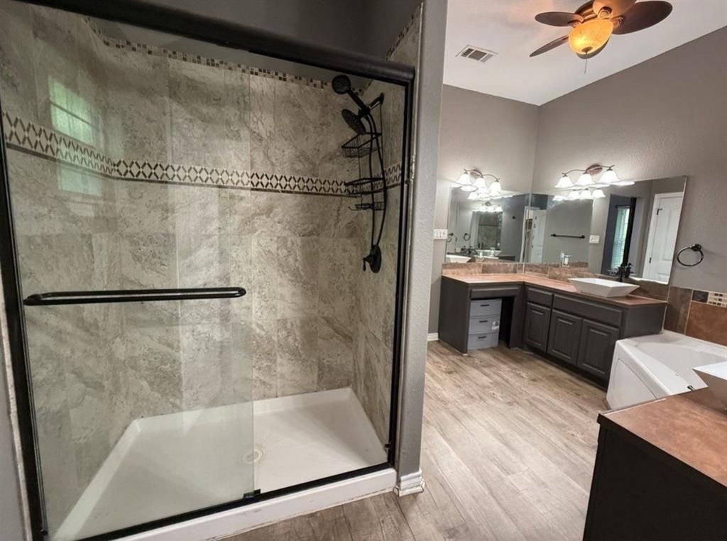 400 North Ave A Springtown, TX 76082 - Photo 15 of 19 a bathroom with a tub sink mirror and shower