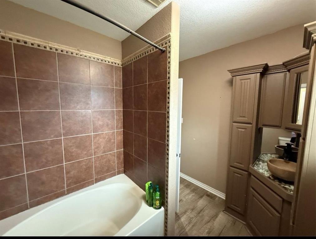 400 North Ave A Springtown, TX 76082 - Photo 19 of 19 a bathroom with a shower and a sink