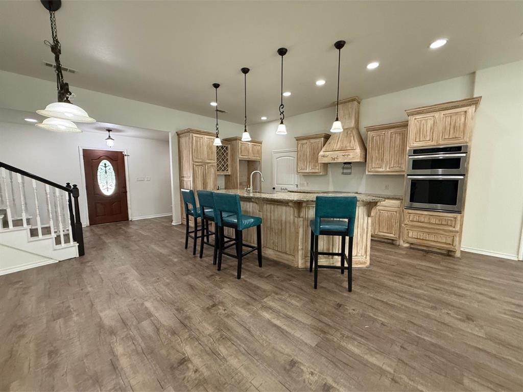 400 North Ave A Springtown, TX 76082 - Photo 8 of 19 a kitchen with stainless steel appliances kitchen island granite countertop a table chairs and a refrigerator