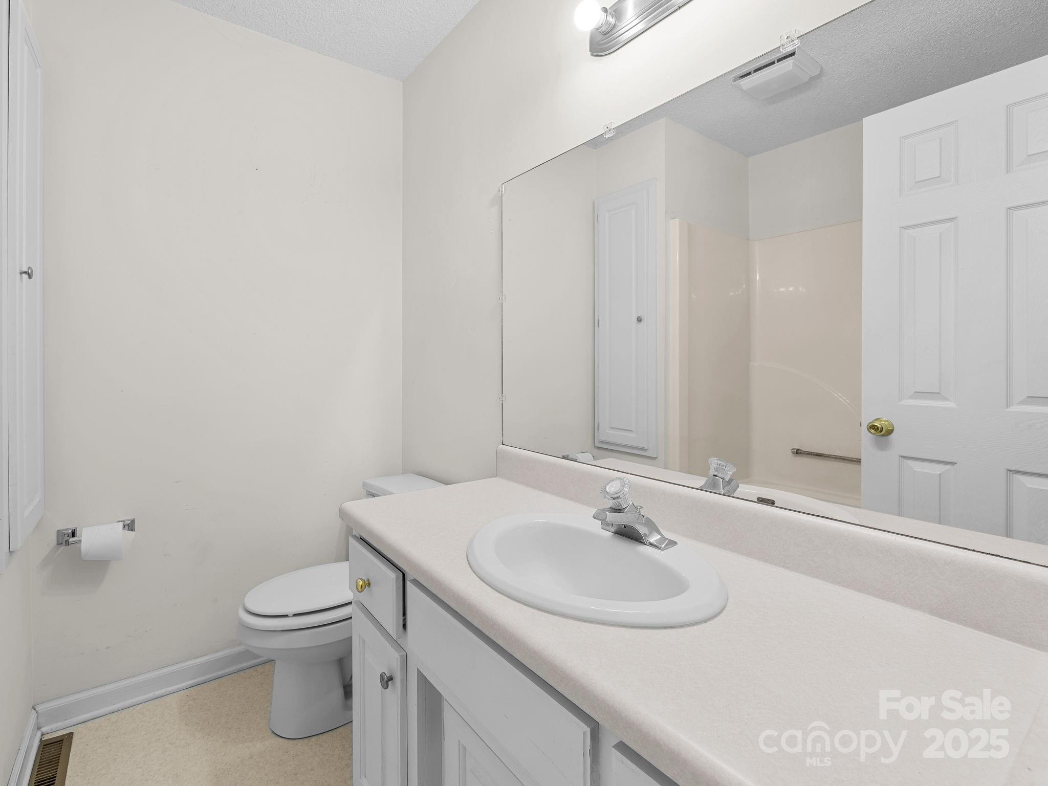 383 Woody Circle Tryon, NC 28782 - Photo 25 of 36 a bathroom with a sink toilet and a mirror