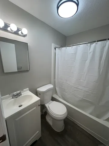 a bathroom with a toilet a sink and bathtub