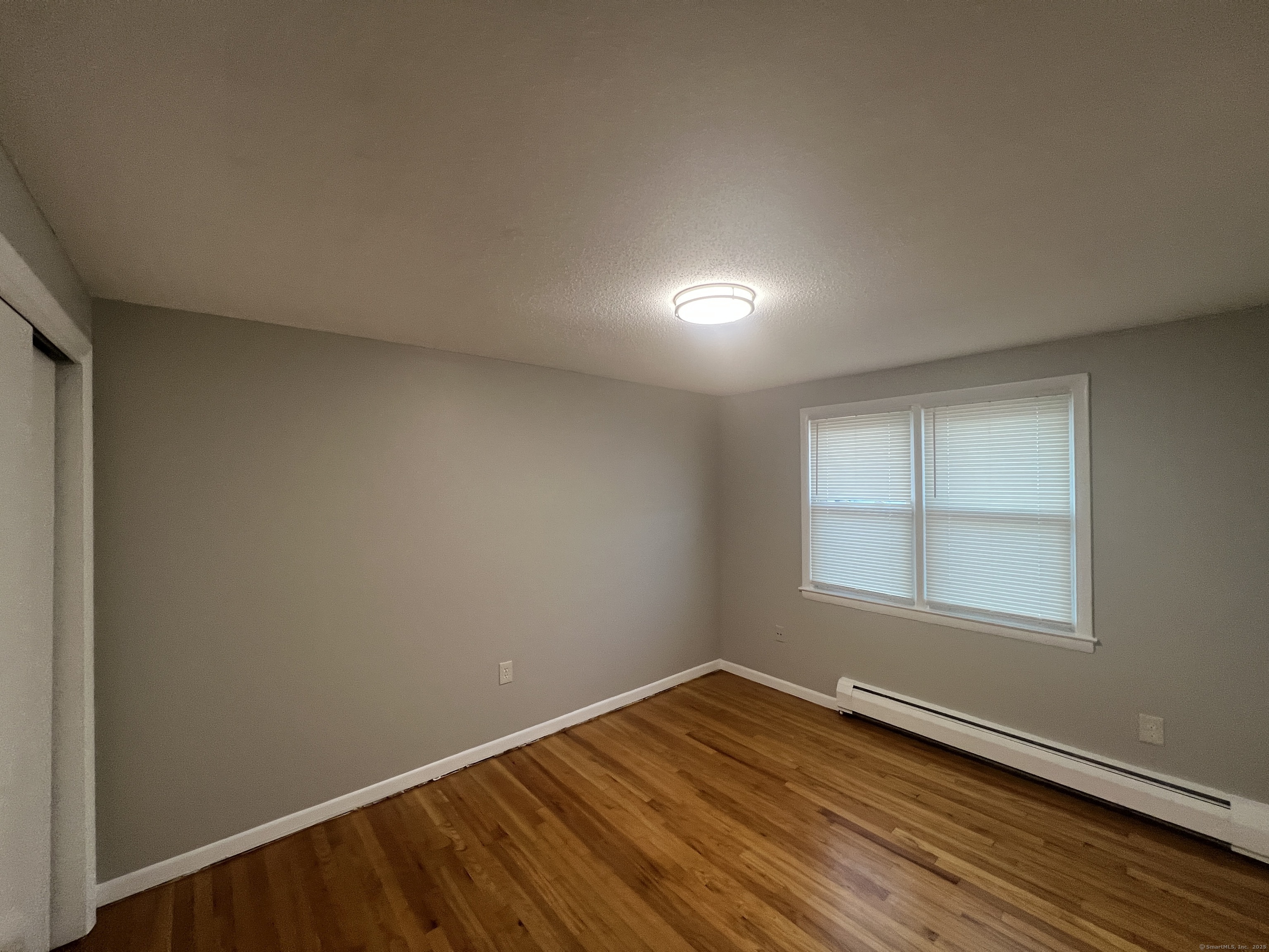 119 Frederick Street, Unit 2R New Haven, CT 06515 - Photo 10 of 14 an empty room with wooden floor and windows