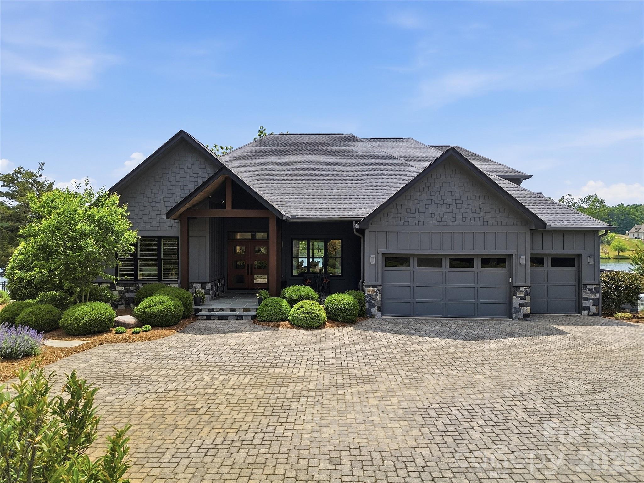 984 Mapleton Lane Tryon, NC 28782 - Photo 2 of 47 a front view of a house with a yard and potted plants