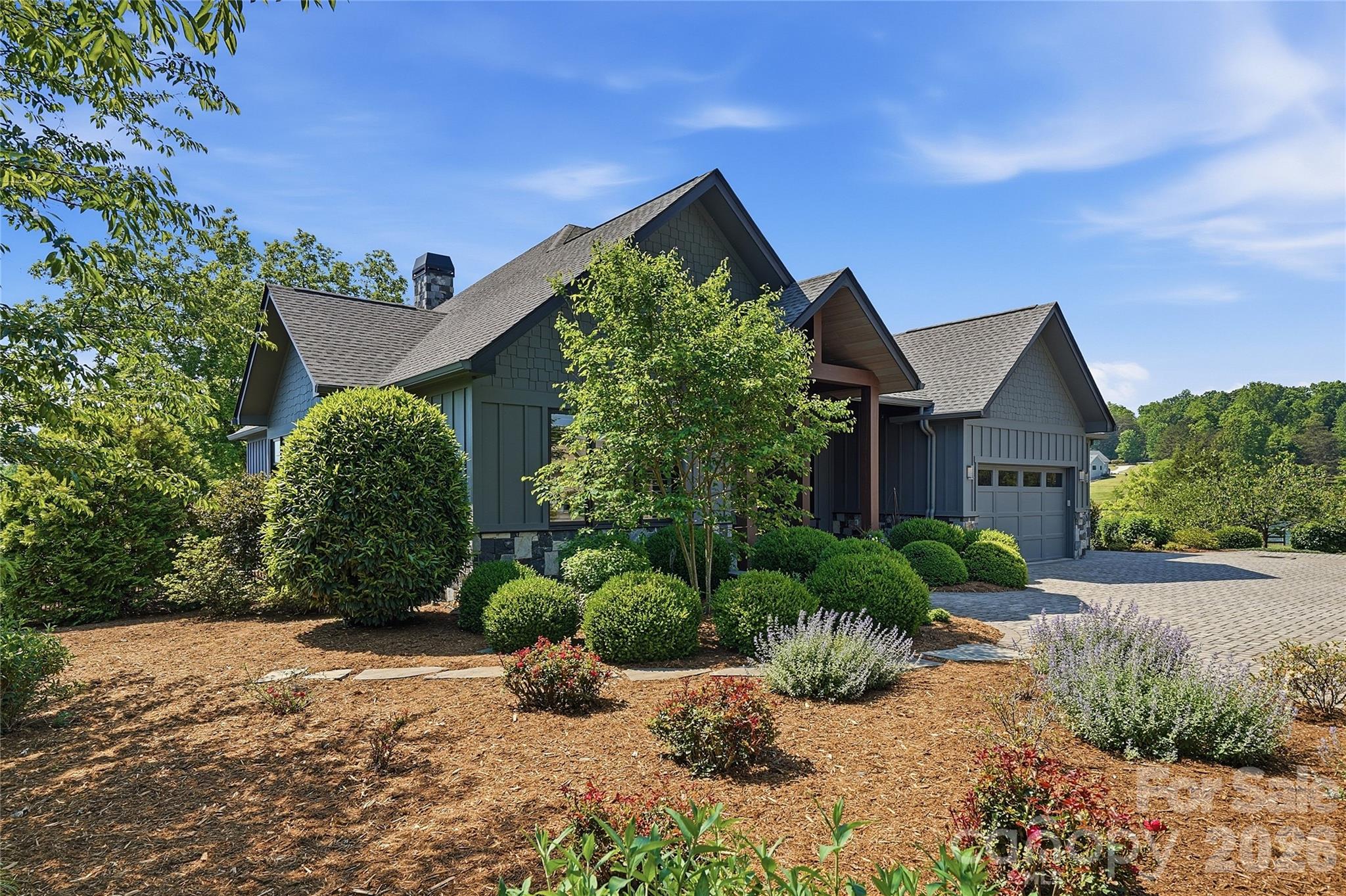 984 Mapleton Lane Tryon, NC 28782 - Photo 3 of 47 a front view of a house with garden