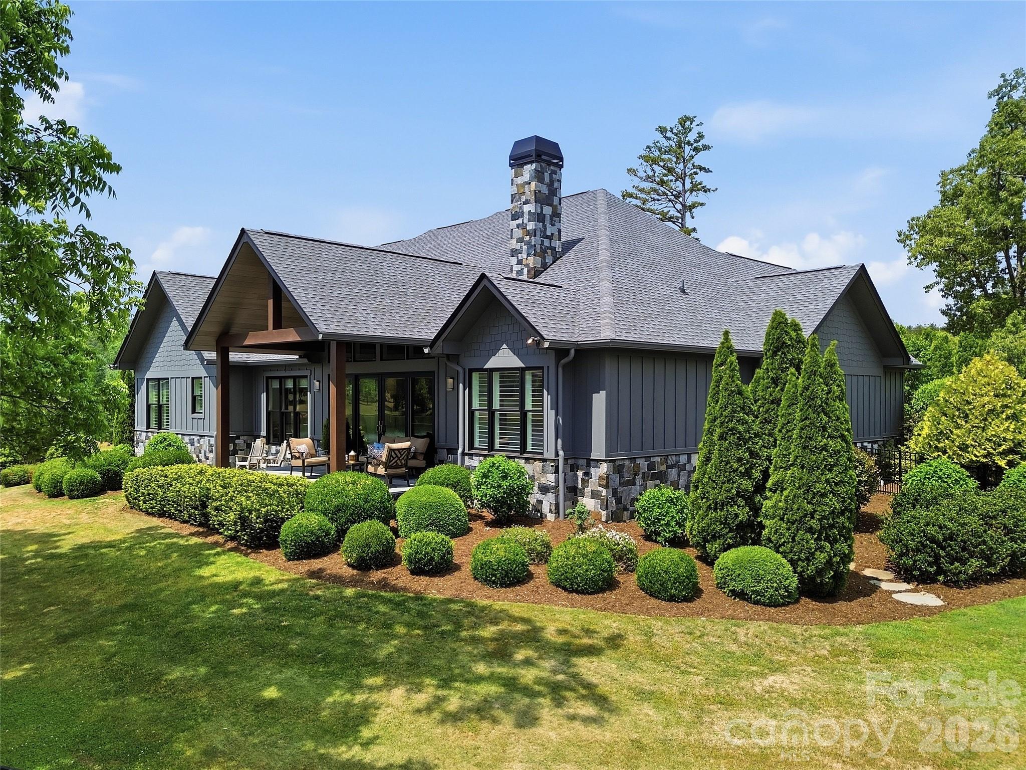 984 Mapleton Lane Tryon, NC 28782 - Photo 40 of 47 a front view of a house with a yard and potted plants