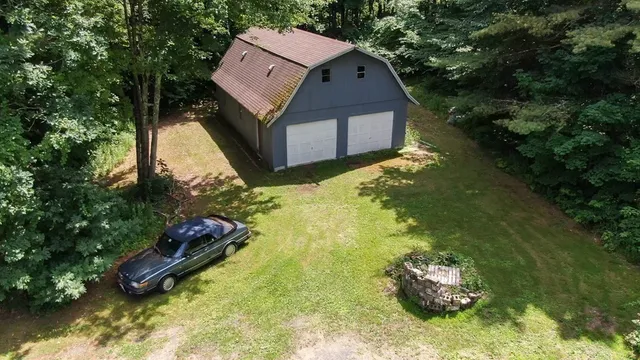 a small pool with some trees in the background