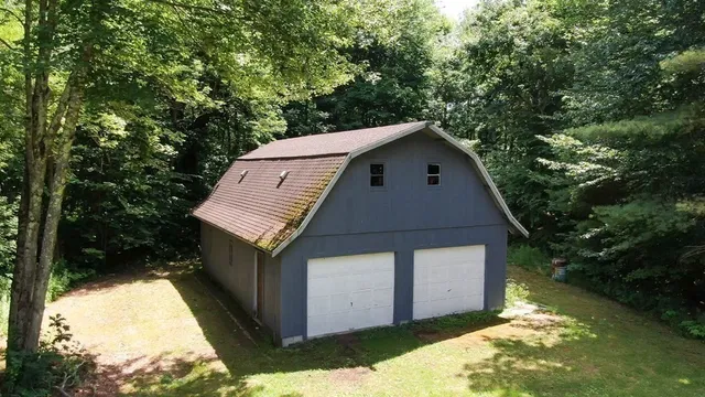 a aerial view of a house with a yard garage and tree