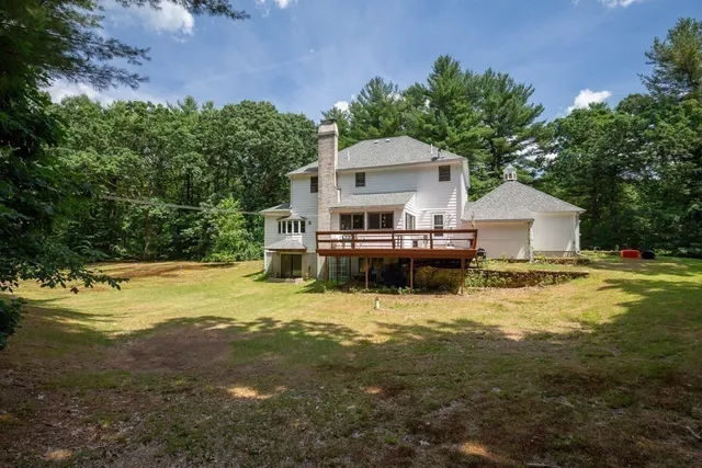 a view of a house with pool and sitting area