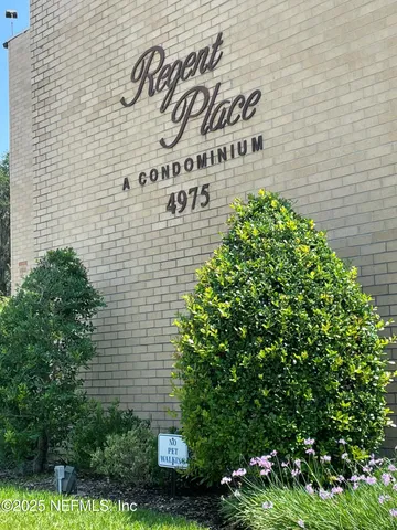 a sign that is on a brick wall