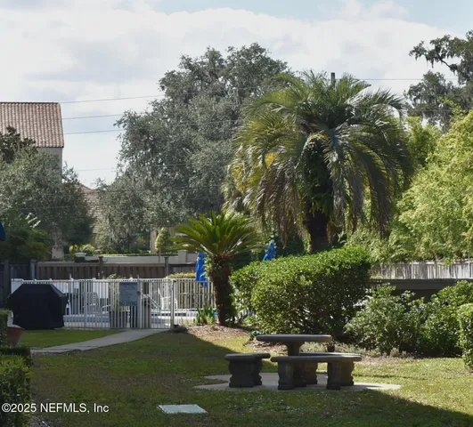 a view of a garden with lawn chairs