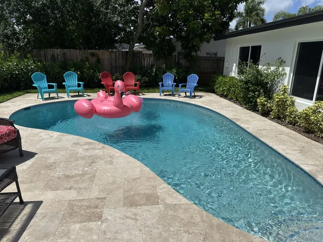 a backyard of a house with table and chairs