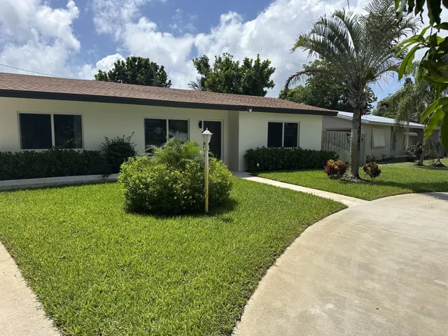 a view of a house with a yard and plants