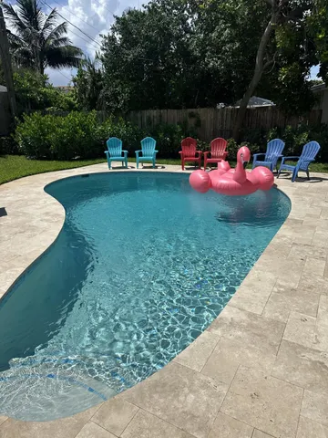 a backyard view with a seating space